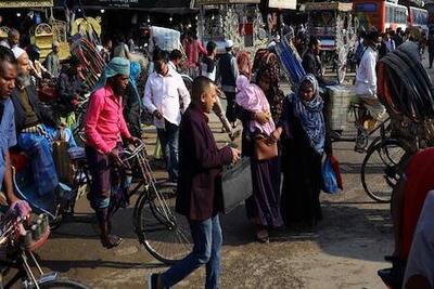 crowd of people walking down a street