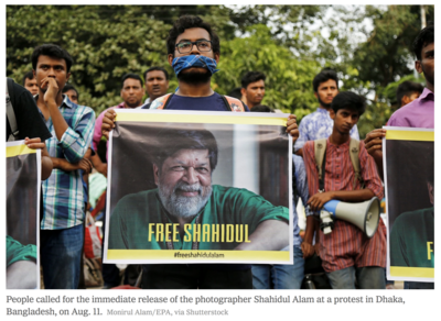 people holding banners demanding the release of Shahidul Alam